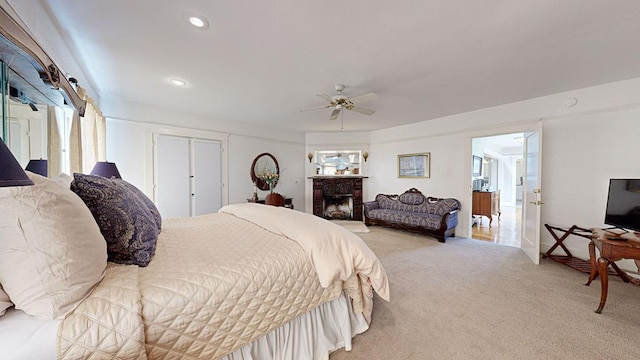 bedroom featuring multiple windows, ceiling fan, and light carpet