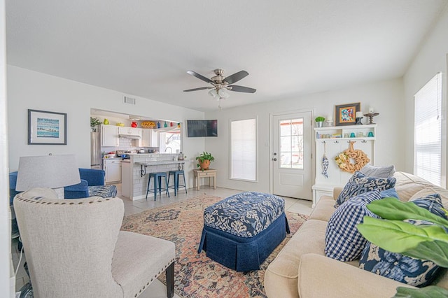 living room featuring ceiling fan and light tile patterned floors