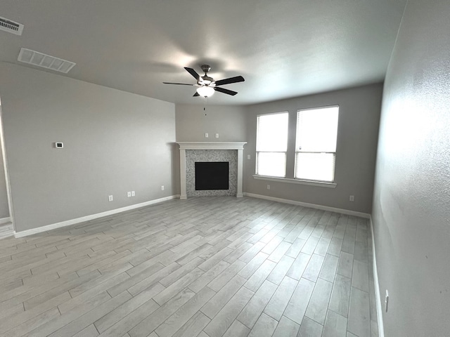 3108 Mearns Ct, Midland, TX 79705 - unfurnished living room featuring ceiling fan, light wood finished floors, baseboards, and a fireplace