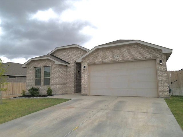 3108 Mearns Ct, Midland, TX 79705 - view of front of home with brick siding, driveway, and an attached garage