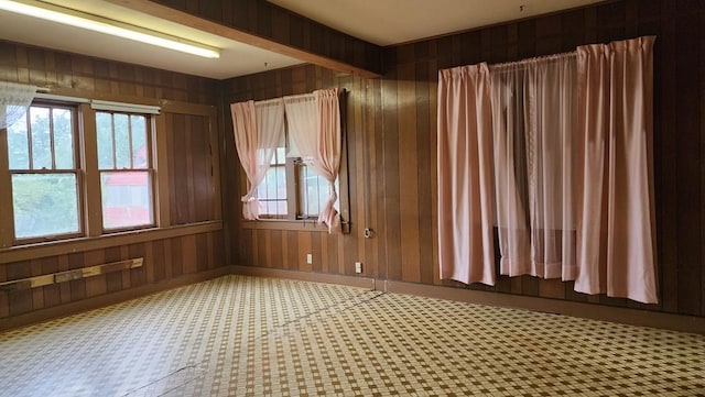 spare room featuring wooden walls