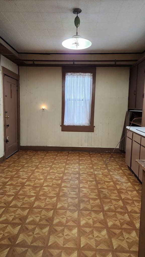 interior space featuring light floors and baseboards