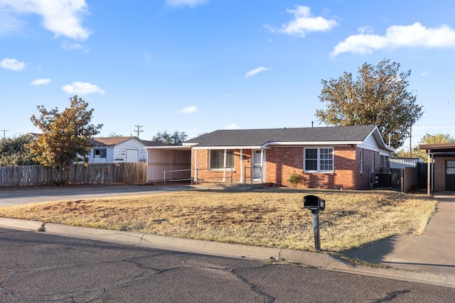 ranch-style home featuring a carport and cooling unit