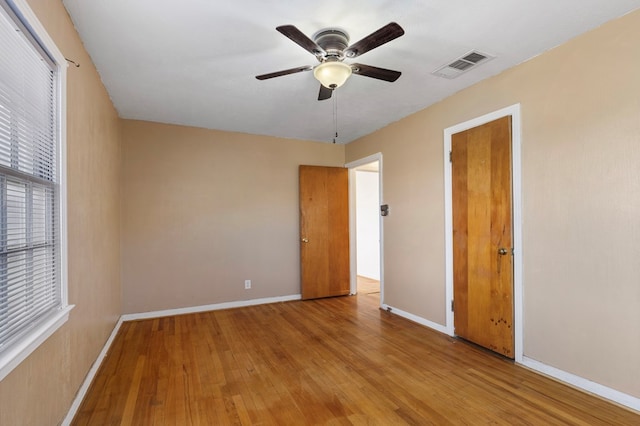 empty room featuring ceiling fan and light hardwood / wood-style floors