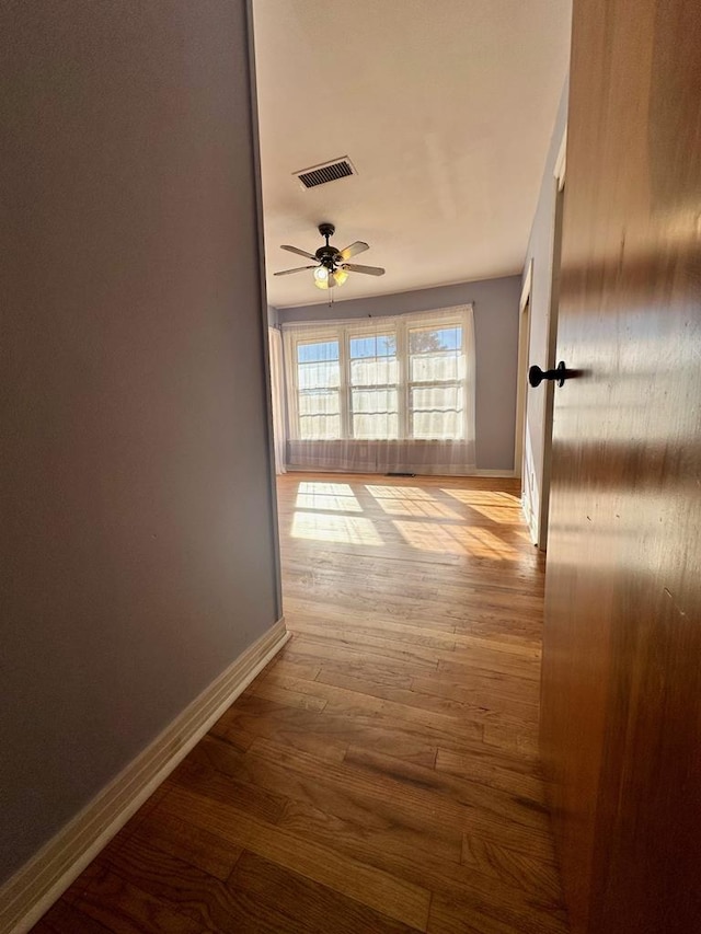 hallway with light hardwood / wood-style floors