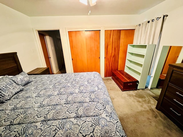 carpeted bedroom featuring two closets