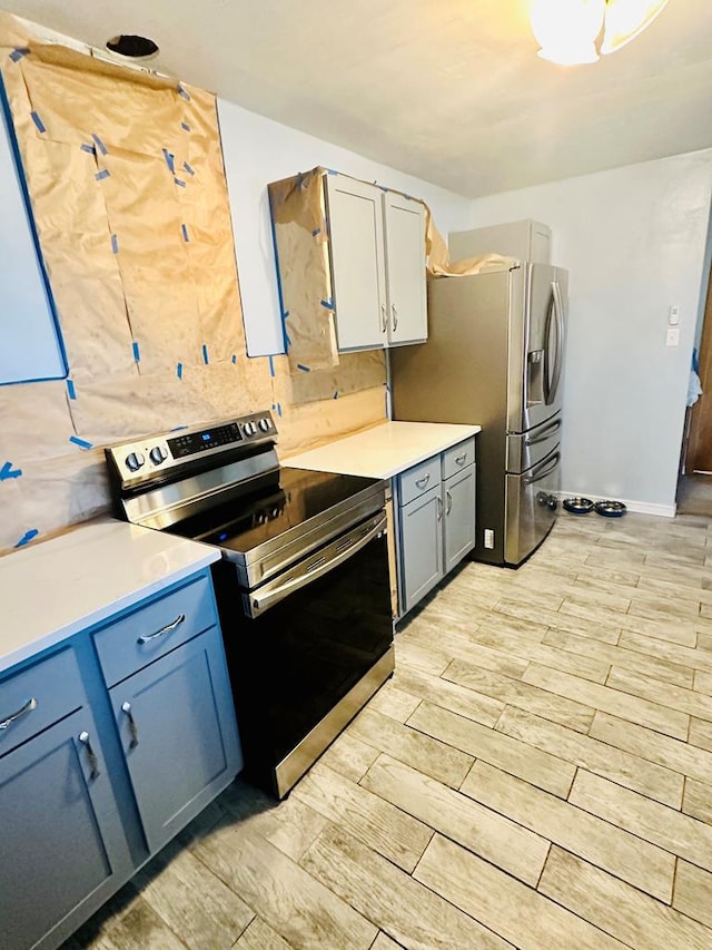 kitchen featuring decorative backsplash, light hardwood / wood-style flooring, and stainless steel appliances