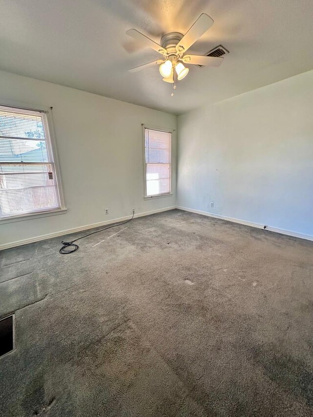 empty room with carpet flooring and ceiling fan