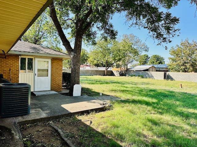 view of yard featuring central air condition unit and a patio