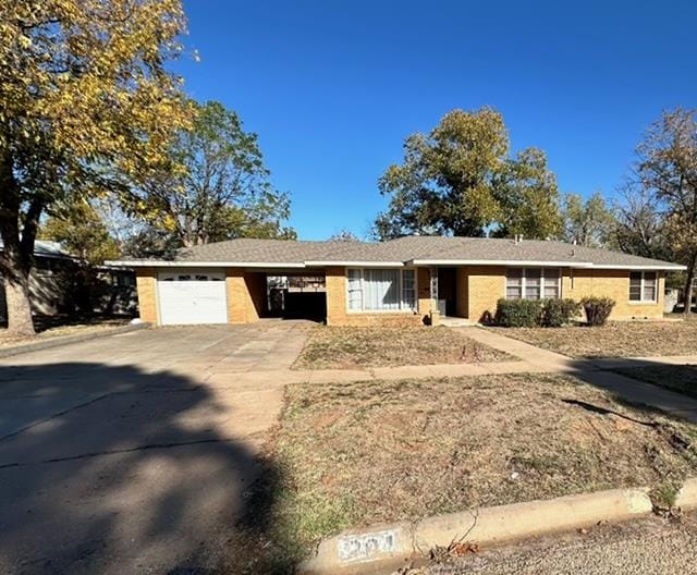 view of front of property featuring a carport and a garage