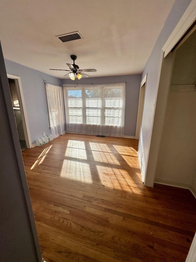 unfurnished bedroom featuring ceiling fan and light wood-type flooring