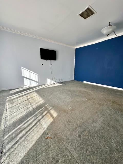 unfurnished living room featuring carpet flooring and crown molding