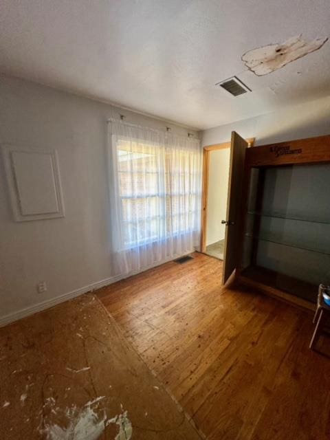 spare room with hardwood / wood-style floors