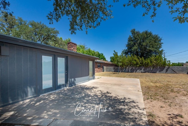 view of yard with fence and a patio