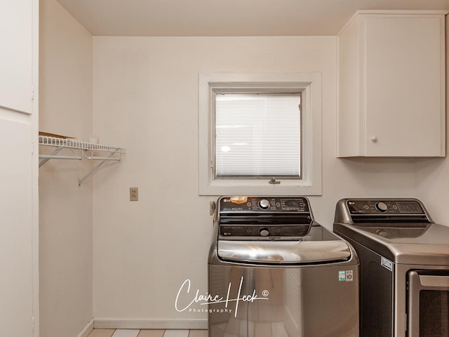 laundry room with baseboards, cabinet space, and washing machine and clothes dryer