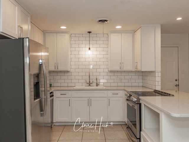 kitchen with light tile patterned floors, tasteful backsplash, visible vents, appliances with stainless steel finishes, and white cabinetry