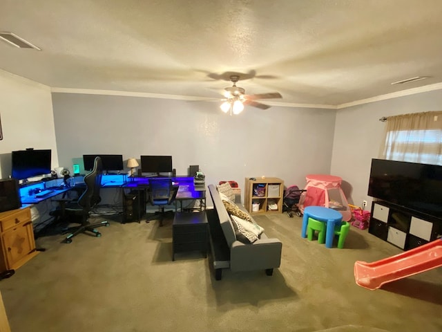 recreation room featuring carpet, a textured ceiling, ceiling fan, and crown molding