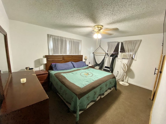 bedroom featuring dark colored carpet, a textured ceiling, and ceiling fan