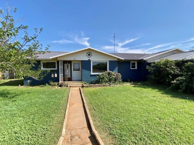 910 Culp Ave, Coahoma, TX 79511 - ranch-style home with a front yard, metal roof, and brick siding