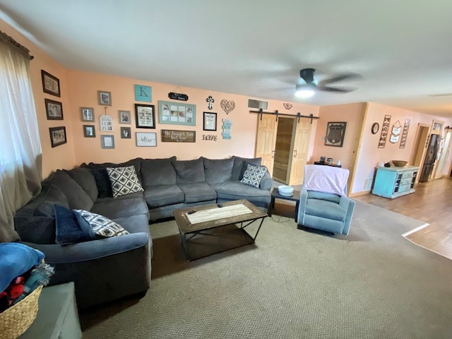 910 Culp Ave, Coahoma, TX 79511 - living room with a barn door, a ceiling fan, and wood finished floors