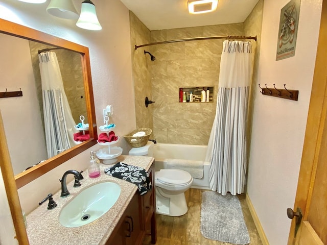 full bathroom featuring toilet, hardwood / wood-style floors, vanity, and shower / tub combo with curtain