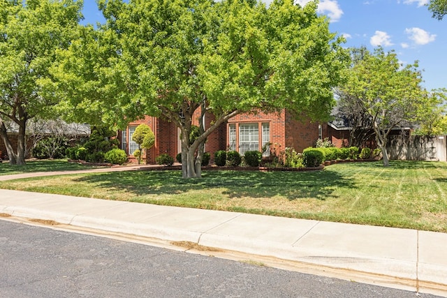 5708 Ridgemont Pl, Midland, TX 79707 - obstructed view of property featuring brick siding and a front lawn