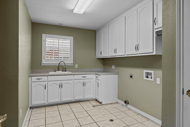 5708 Ridgemont Pl, Midland, TX 79707 - laundry area with hookup for an electric dryer, washer hookup, cabinet space, and light tile patterned floors