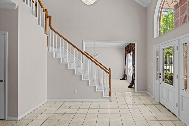 5708 Ridgemont Pl, Midland, TX 79707 - entrance foyer with a chandelier, stairs, a towering ceiling, crown molding, and light tile patterned floors