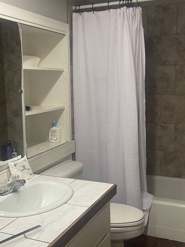 3000 W Illinois Ave Unit 24, Midland, TX 79701 - bathroom featuring toilet, vanity, and shower / tub combo with curtain