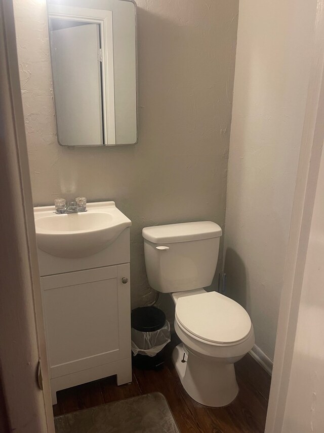 3000 W Illinois Ave Unit 24, Midland, TX 79701 - bathroom with wood finished floors, vanity, and toilet