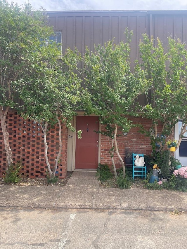 3000 W Illinois Ave Unit 24, Midland, TX 79701 - doorway to property with board and batten siding and brick siding