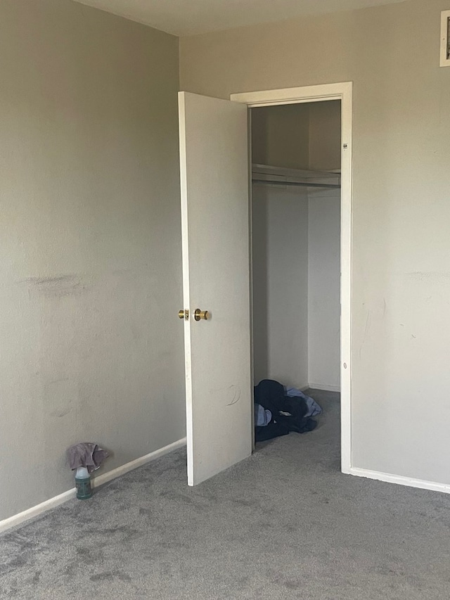 3000 W Illinois Ave Unit 24, Midland, TX 79701 - unfurnished bedroom featuring carpet, a closet, and baseboards