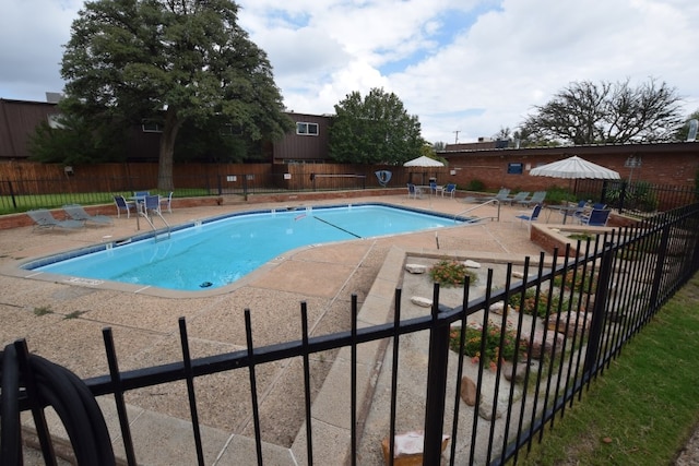 3000 W Illinois Ave Unit 24, Midland, TX 79701 - community pool featuring a patio and fence