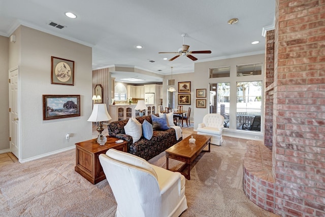 carpeted living room featuring ornamental molding and ceiling fan