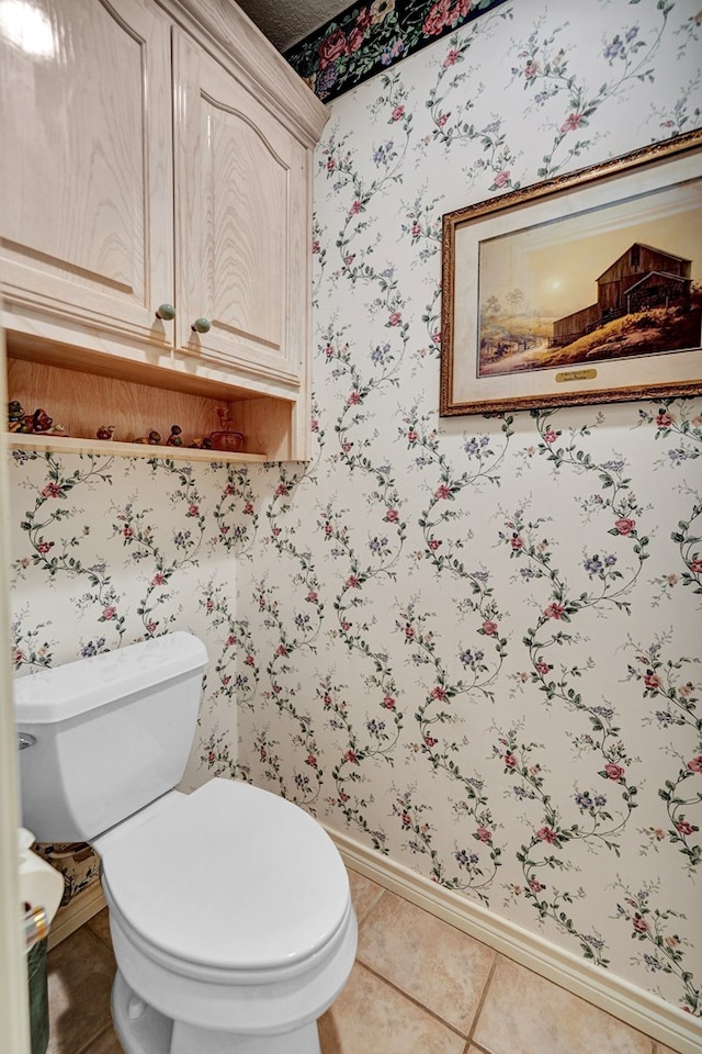 bathroom with tile patterned flooring and toilet