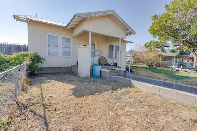 bungalow-style home featuring a front yard