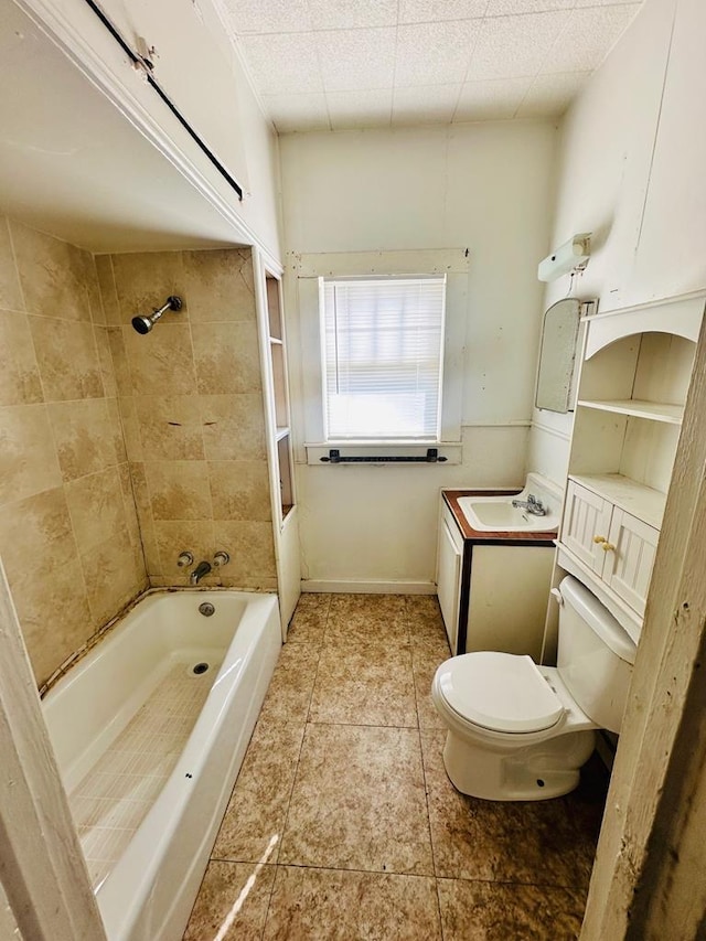 full bathroom with toilet, tiled shower / bath combo, and sink