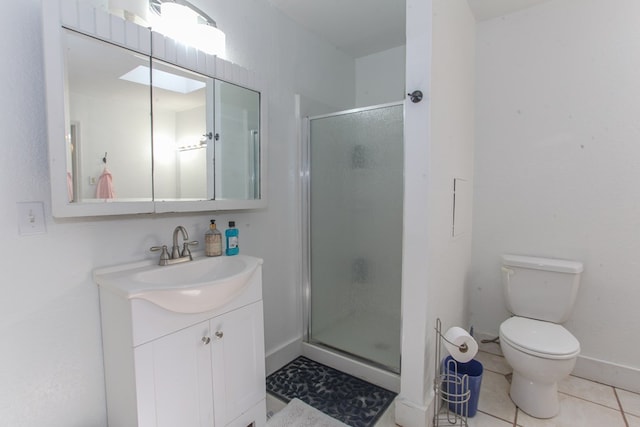 bathroom with vanity, tile patterned flooring, a shower with shower door, and toilet