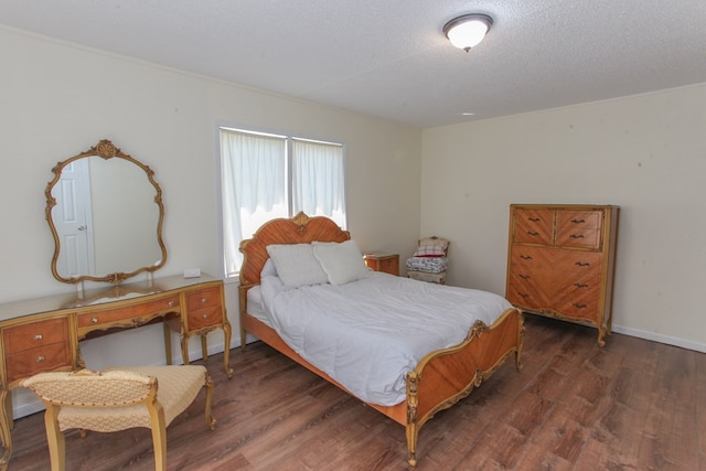 bedroom featuring dark wood-type flooring and a textured ceiling