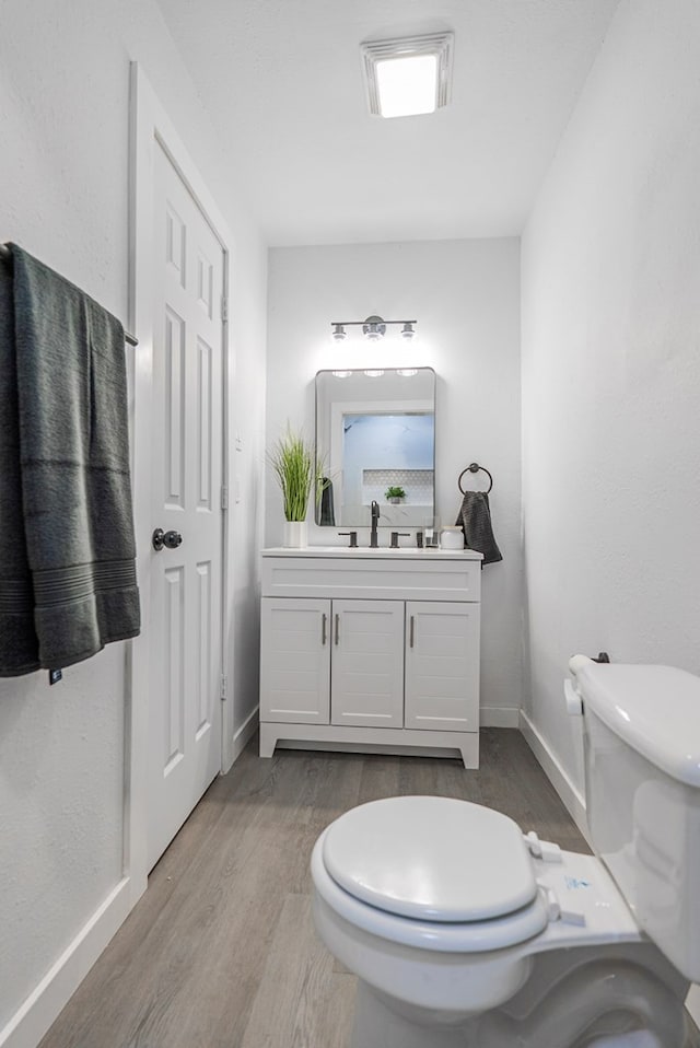 4604 Versailles Dr, Midland, TX 79703 - half bathroom featuring wood finished floors and vanity