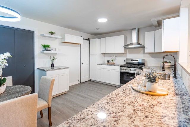 4604 Versailles Dr, Midland, TX 79703 - kitchen with wall chimney range hood, stainless steel gas range, light stone countertops, and white cabinets