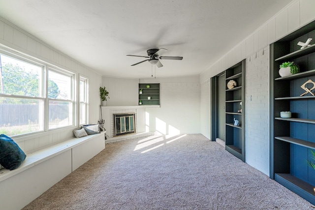 4604 Versailles Dr, Midland, TX 79703 - unfurnished living room with carpet floors, a fireplace, and ceiling fan