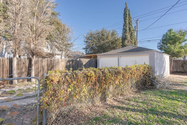 detached garage featuring fence