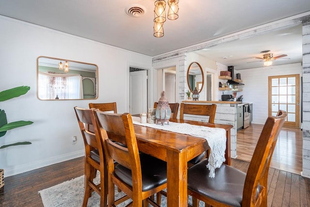 dining space featuring ceiling fan, wood-type flooring, visible vents, and baseboards