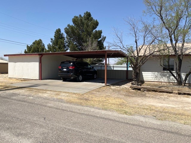 view of vehicle parking featuring fence