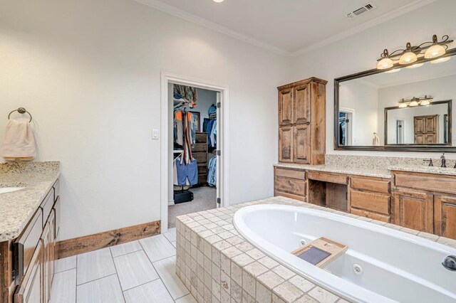 full bathroom featuring vanity, crown molding, a tub with jets, tile patterned floors, and baseboards