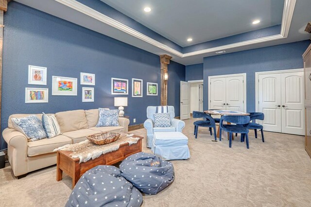 carpeted living room with a raised ceiling, recessed lighting, and decorative columns