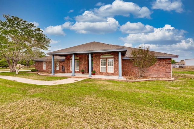 5709 E County Rd 97, Midland, TX 79706 - back of property featuring brick siding and a lawn