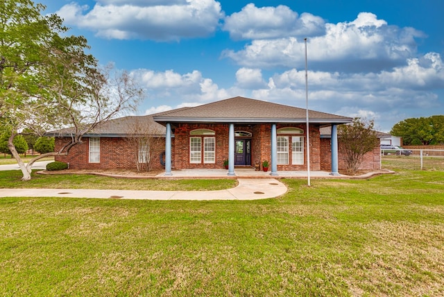 5709 E County Rd 97, Midland, TX 79706 - view of front facade featuring a front yard, fence, and brick siding