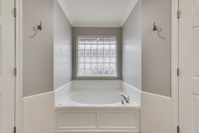 5709 E County Rd 97, Midland, TX 79706 - bathroom with tile walls, a textured wall, ornamental molding, a textured ceiling, and a bath